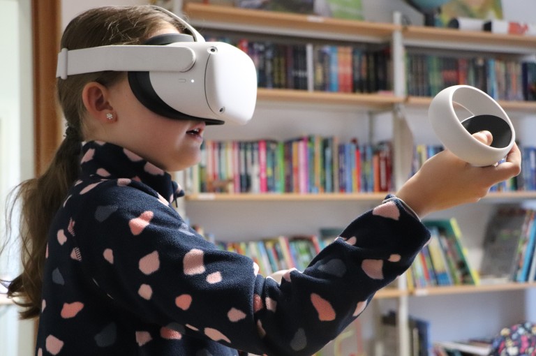Junges Mädchen testet VR-Brille.